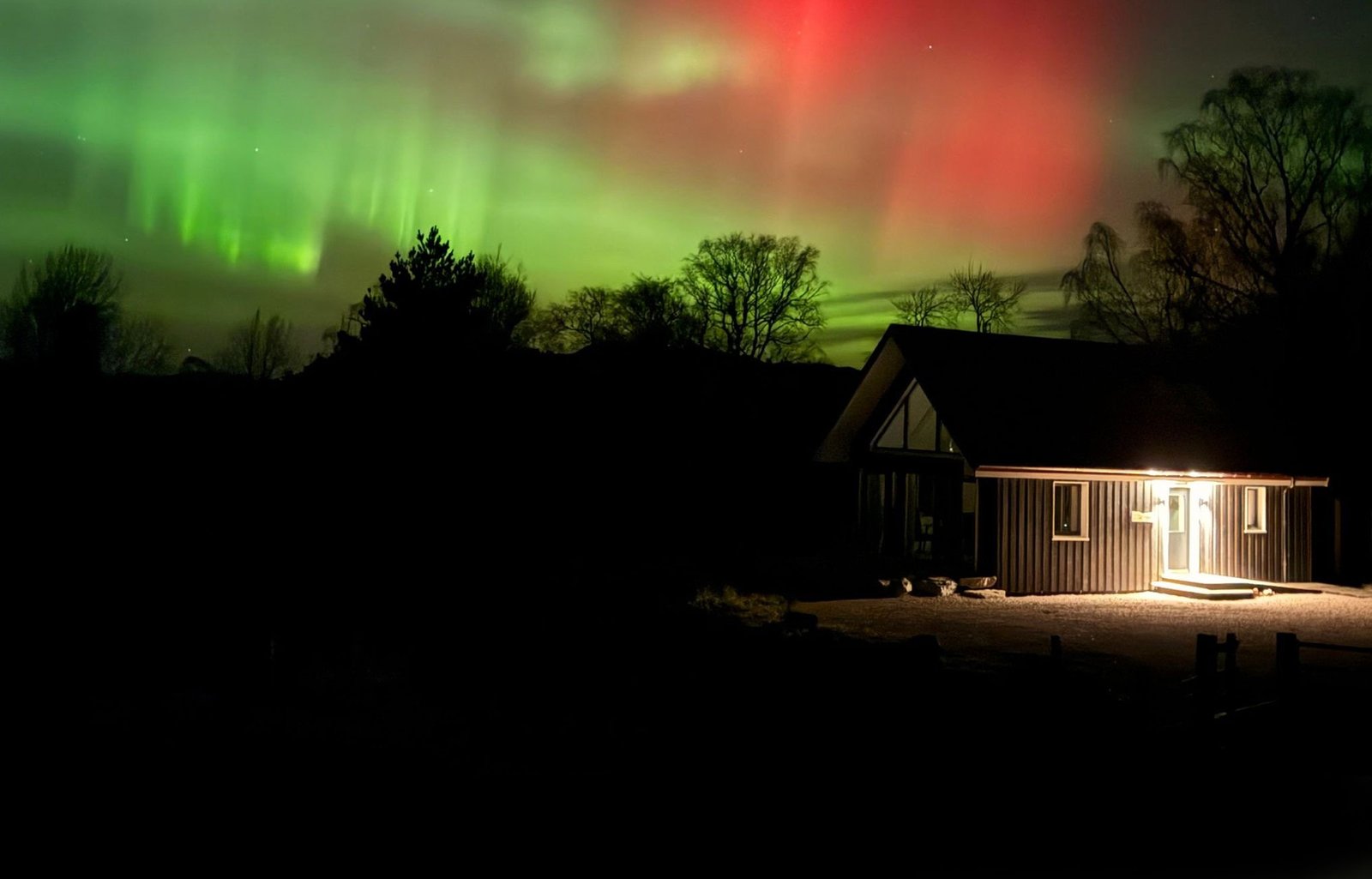 A cabin beneath a dark starry sky